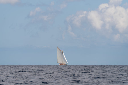 Alone classic yacht sailing in open sea
