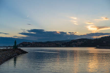 Colorful clouds at sunset with cityscape - Imperia, Liguria, Italyの写真素材
