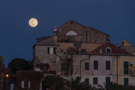 Full moon over Cervo medieval village, Province of Imperia, Liguria region of Italyの写真素材