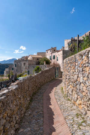 View along narrow street in the ancient village of Verezzi in the Ligurian Rivieraの写真素材