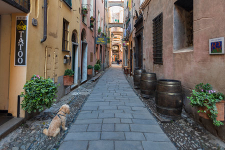 Finale Ligure, Italy - April 8, 2019: View along narrow street in the medieval village of Finalborgo in Province of Savona, Liguria region, Italyのeditorial素材