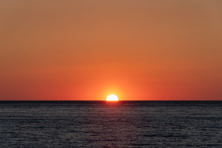 Mediterranean sea as the sun starts to rise and colour it golden, Liguria, Italy
