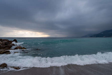Clouds over the sea in soft sunlight in wintertime, Varigotti, Liguria, Italyの写真素材
