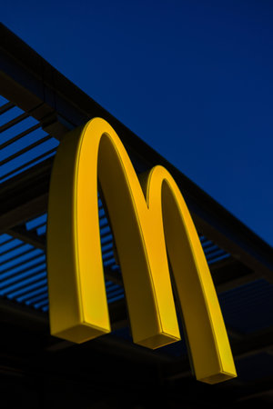 Imperia, Italy - May 7, 2020: Logo sign outside of a McDonald's fast food restaurant at night in Imperia, Italyのeditorial素材