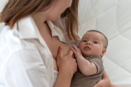 Mother breastfeeding her 3 months old baby girl