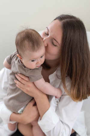 Mother kissing head of baby