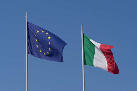 Flag of European Union and Italy in blue skyの写真素材