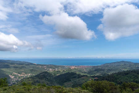 View of the Gulf of Diano Marina protected by mountains covered by Mediterranean vegetation, Province of Imperia, Liguria region, Italyの写真素材