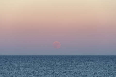 Moonrise over seaの写真素材