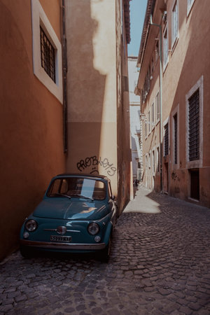 Rome, Italy - June 14, 2021: A narrow ancient alley with cobblestone in the historic center of Rome