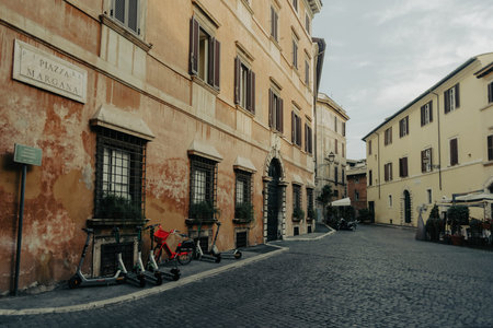 Rome, Italy - June 14, 2021: A narrow ancient alley with cobblestone in the historic center of Rome