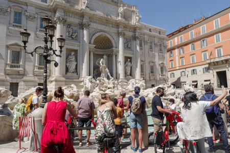 Rome, Italy - June 12, 2021: Tourists in Rome enjoy majestic view of Trevi Fountainのeditorial素材
