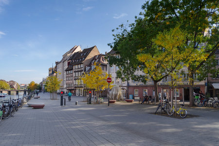 Strasbourg, France - October 25, 2021: Ill River canal with promenade and row of town houses