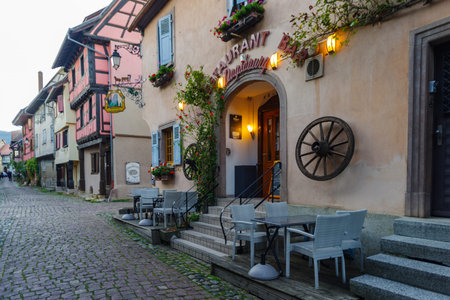 Eguisheim, France - October 24, 2021: View along cobblestone street in the historic village of Eguisheim surrounded well-preserved half-timbered buildings, Alsace region in Eastern Franceのeditorial素材