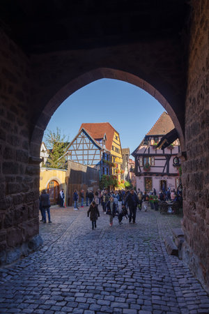 Riquewihr, France - October 24, 2021: View along main pedestrian street in the medieval village of Riquewihr surrounded well-preserved half-timbered buildings, Alsace region in Eastern Franceのeditorial素材