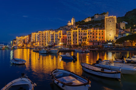 Illuminated buildings by sea at night, Porto Venere, Liguria, Italyの写真素材
