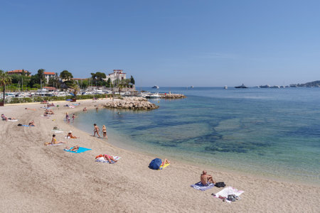 Beaulieu-sur-Mer, France - May 12, 2022: People relaxing on the beach in Beaulieu - the town of famous tourist destination in French Rivieraのeditorial素材