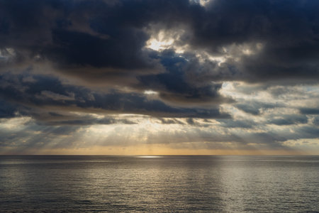 Dark cumulus clouds hovering over the sea