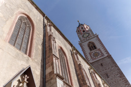 Clock tower with a sundial of Church of San Nicolo, Merano, South Tyrol, Italyの写真素材
