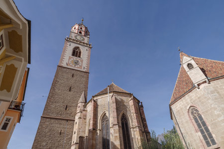 Clock tower with a sundial of Church of San Nicolo, Merano, South Tyrol, Italy