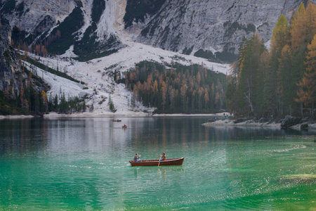Braies, Italy - October 30, 2022: Tourists at rowing boat on Lake Braies enjoy the sunnny day, Dolomite Alps, South Tyrolのeditorial素材