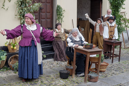 Taggia, Italy - February 26, 2023: Participants of historical reenactment in the old town of Taggia, in Liguria region of Italy. The actors acting out episodes of daily life in settings that evoke moments of life lived fully the seventeenth century. The eのeditorial素材