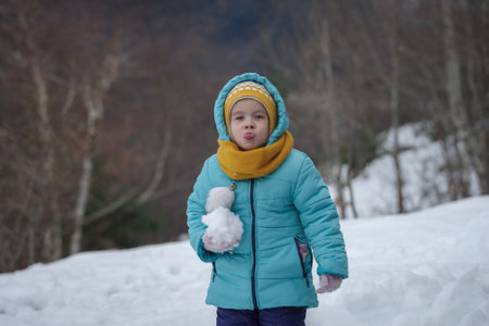 Little happy girl play with snowの写真素材