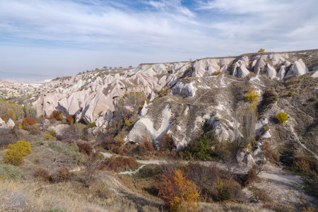 Dwellings carved in stone, in volcanic rock formations eroded by water in the open air museum in Cappadocia, Anatolia, Turkeyの写真素材