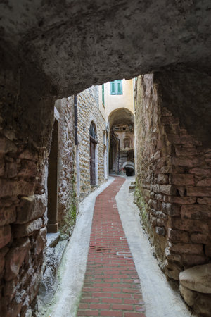 View along narrow street in the medieval village of Ceriana in Province of Imperia, Liguria region, Italyの写真素材