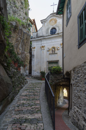 View along narrow street in the medieval village of Ceriana in Province of Imperia, Liguria region, Italyの写真素材