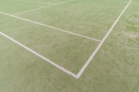 Artificial green turf with white painted lines on an open sports fieldの写真素材