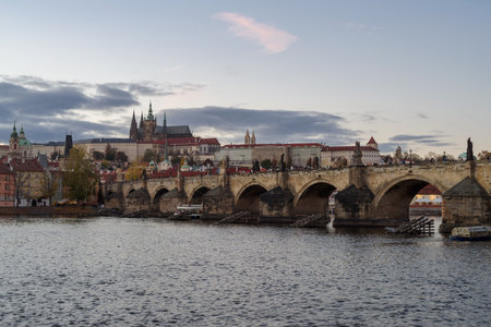 A view of Castle of Prague and Charles bridge on an autumn day, close before the sunsetの写真素材