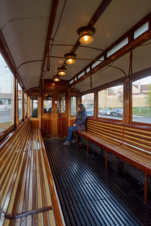 Prague, Czech Republic - 5 November 2025: Woman inside Prague vintage tram 42, be they from the time of the Austro-Hungarian monarchy, from the 1950s or the 1970s. transporting visitors around Prague. The tram connects the city's sights in a circular routのeditorial素材