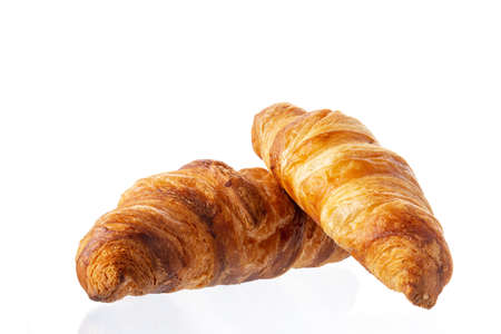Two classic french croissants on a white background. Homemade baking.の写真素材