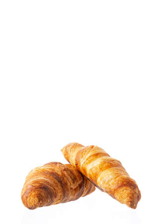 Two classic french croissants on a white background. Homemade baking.の写真素材
