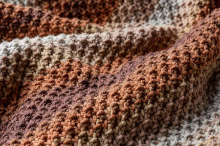 Fragment of a knitted product close-up. Waves on a knitted plaid. Background. Abstraction.の写真素材