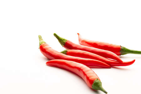 Red chili peppers on a white background. Isolate. Hot peppers. A few fresh pods of red pepper.の写真素材