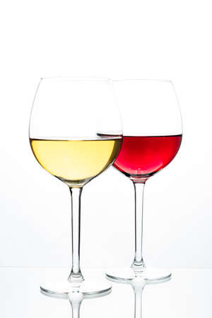 Two glasses with wine on a white background. Red wine. White wine. Apple juice. Cherry juice.の写真素材