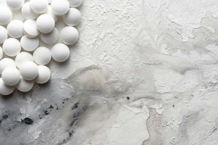 A handful of pills scattered on the table. A vial of medicines. Marble surface. Medicines.の写真素材