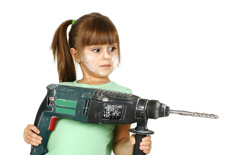 Dirty child girl with electric drill , isolated on white.の写真素材