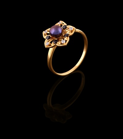 Gold ring with brilliant isolated on black background の写真素材