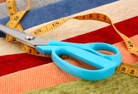 scissors and measuring tape on fabricの写真素材
