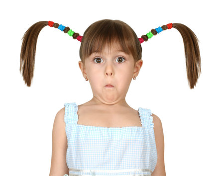 Portrait of funny surprised child girl with long tails isolated on white
