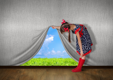 Child raise the wall and look on nature,の写真素材