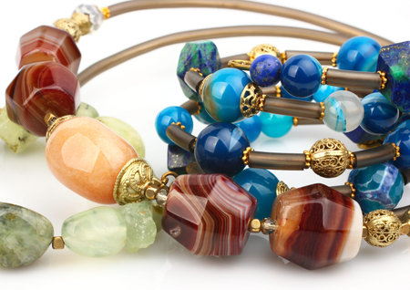 Close-up of colorful natural precious gems jewelry on white