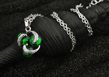 jewelry pendant with gems on black backgroundの写真素材