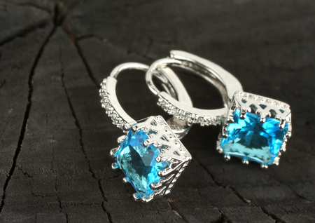 jewelry Earrings on black wood background, copy-spaceの写真素材