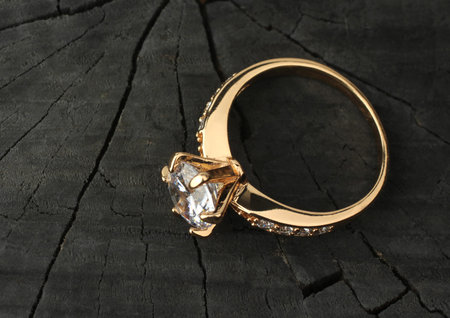 Jewelry ring with diamond on black wood backgroundの写真素材