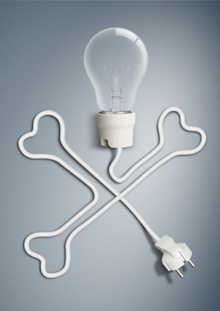 electricity concept, light bulb with cable as bone skullの写真素材