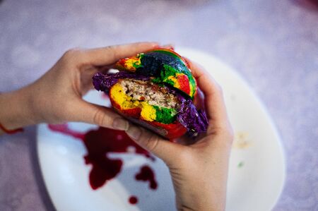A hand holding a piece of cake on a plate. High quality photoの写真素材